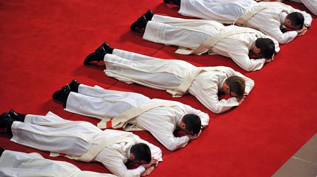 Priesteranwärter liegen als Zeichen der Demut bäuchlings auf dem Teppich (Freiburger Dom); Foti: dpa 